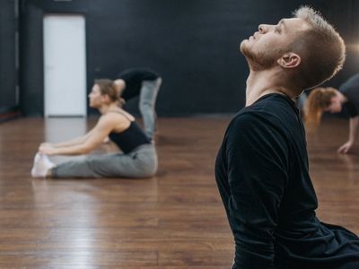 Creative person doing stretching in studio